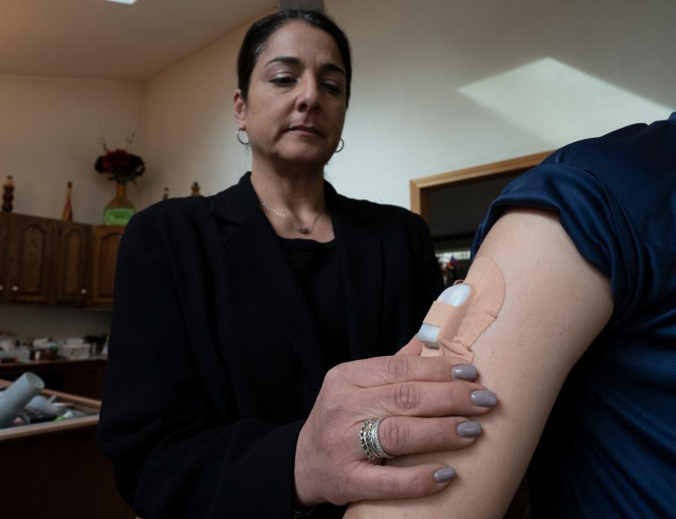 Maria Chiodi helps her son use the Omnipod 5 insulin pump. The boy no longer misses classroom time to take insulin shots and avoids blood sugar highs and lows when he plays sports.