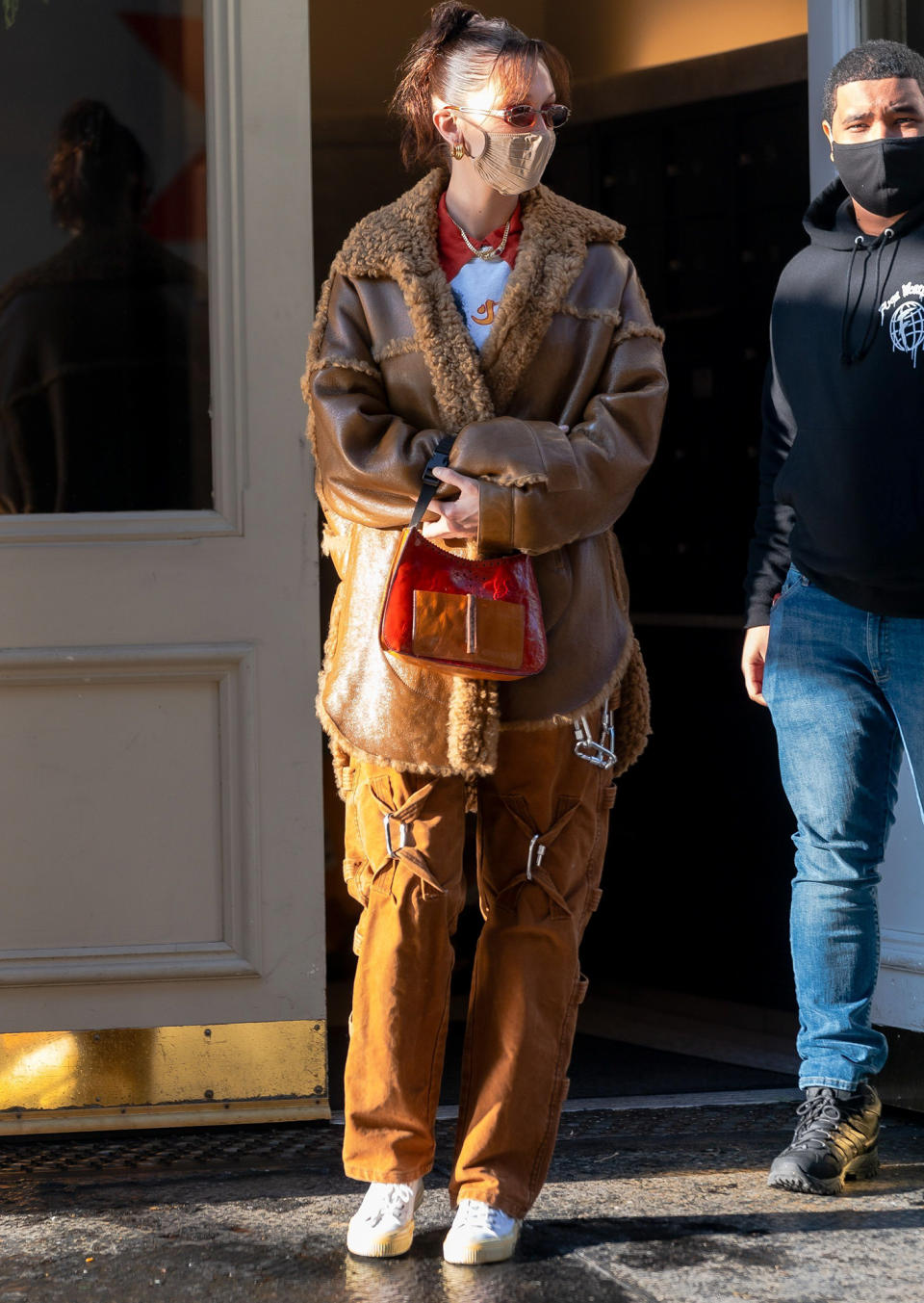 <p>Bella Hadid bundles up in a cozy brown coat as she steps out in N.Y.C.'s Soho neighborhood on Monday.</p>