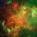 NASA handout image dated February 2011 shows a swirling landscape of stars known as the North America Nebula. In visible light, the region resembles North America, but in this image infrared view from NASA's Spitzer Space Telescope, the continent disappears. The reason you don't see it in Spitzer's view has to do, in part, with the fact that infrared light can penetrate dust whereas visible light cannot. Dusty, dark clouds in the visible image become transparent in Spitzer's view. In addition, Spitzer's infrared detectors pick up the glow of dusty cocoons enveloping baby stars. Clusters of young stars (about one million years old) can be found throughout the image. Some areas of this nebula are still very thick with dust and appear dark even in Spitzer's view. The Spitzer image contains data from both its infrared array camera and multi-band imaging photometer. Light with a wavelength of 3.6 microns has been color-coded blue; 4.5-micron light is blue-green; 5.8-micron and 8.0-micron light are green; and 24-micron light is red. REUTERS/NASA/JPL-Caltech/Handout