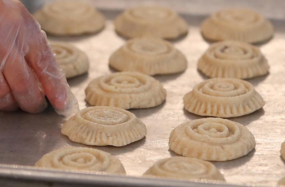 Members of Our Lady of the Cedars prepare ma'mool cookies with dates at the Fairlawn church's banquet hall kitchen July 18.