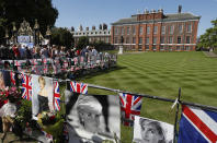 <p>People crowd around the gates of Kensington Palace in London to pay tribute to the late Diana, Princess of Wales, Aug. 31, 2017. (Photo: Kirsty Wigglesworth/AP) </p>