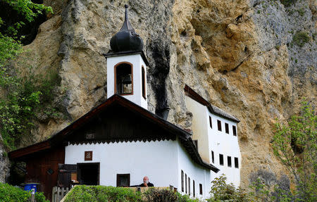 Hermit Stan Vanuytrecht of Belgium smokes a pipe outside his hermitage in Saalfelden, Austria, May 22, 2017. Picture taken May 22, 2017. REUTERS/Leonhard Foeger