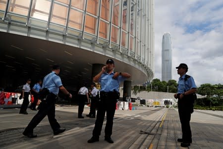 Policemen stand outside the Legislative Council, a day after protesters broke into the building, in Hong Kong