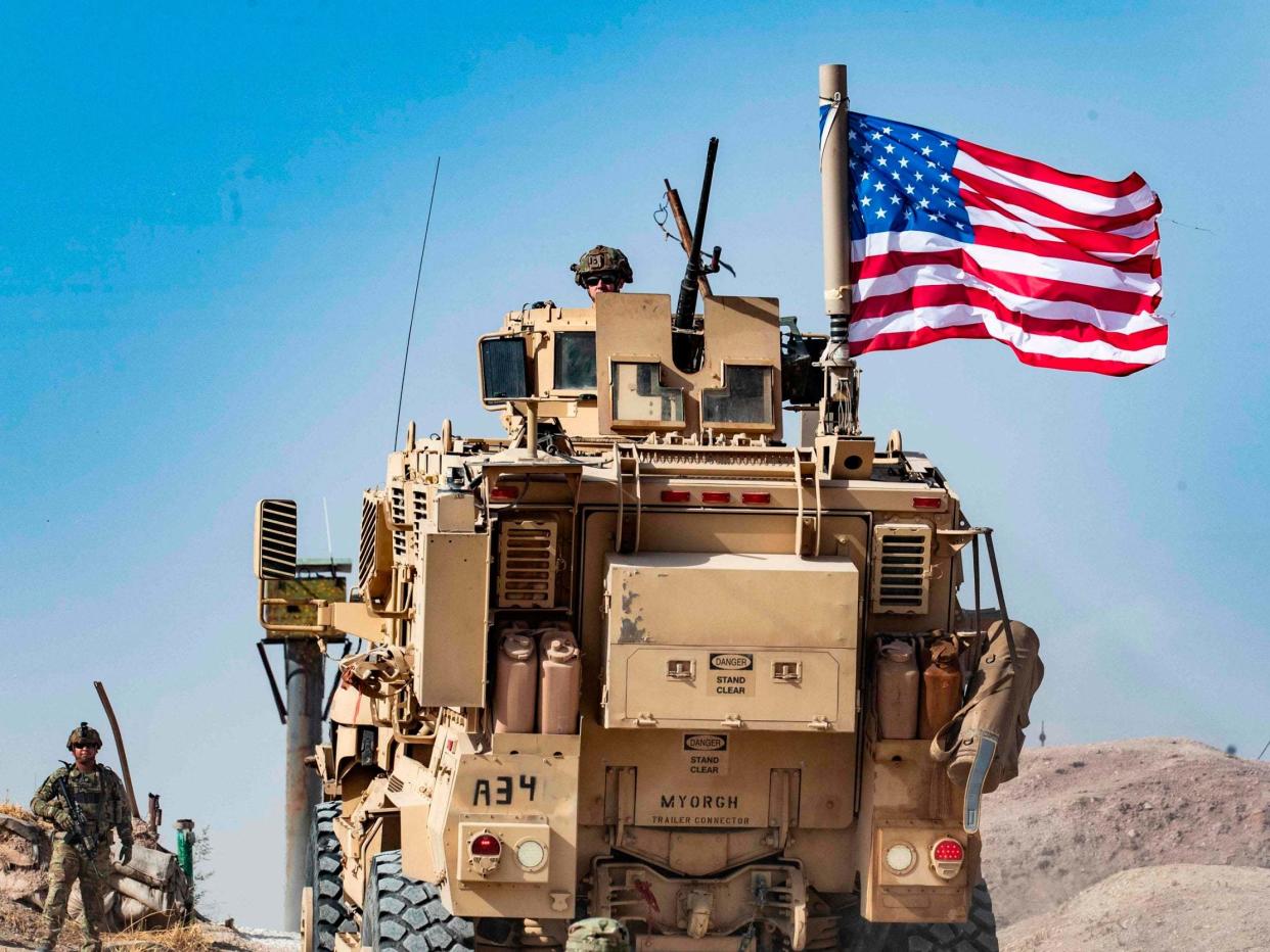 A US soldier on an armoured vehicle in Syria's Hasakeh province close to the Turkish border: AFP