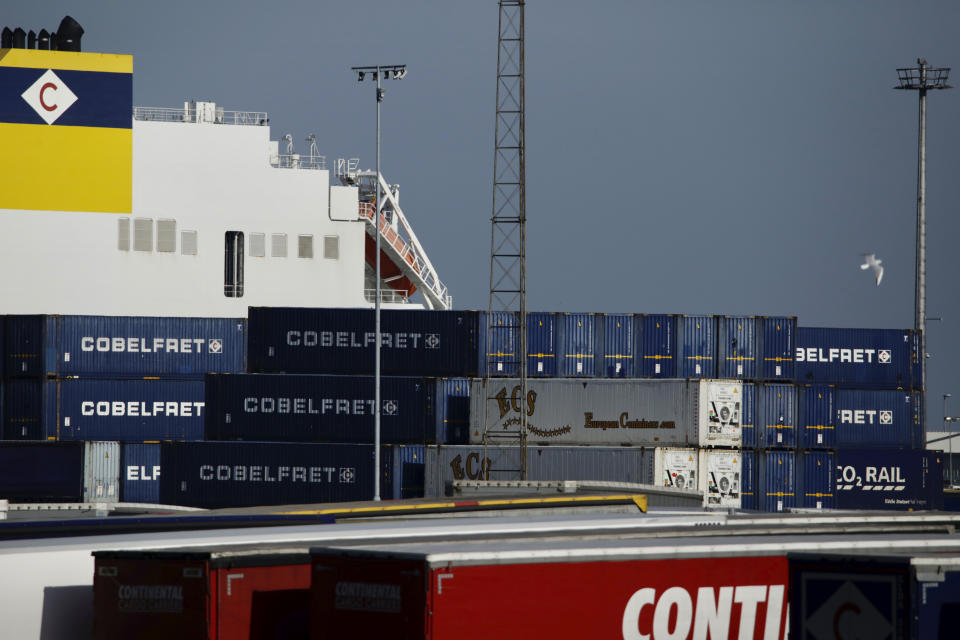 Shipping containers are stacked and ready to load onto a ship at the Port of Zeebrugge, in Zeebrugge, Belgium, Thursday, Oct. 24, 2019. British police raided two sites in Northern Ireland and questioned a truck driver as they investigated the deaths of 39 people found in a truck container that they believe came from Zeebrugge and was found at an industrial park in southeastern England. (AP Photo/Olivier Matthys)