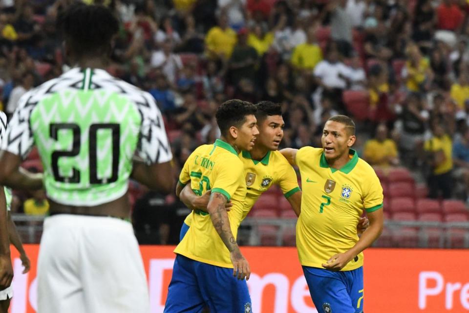 Brazil players Roberto Firmino (left) and Richarlisson (right) celebrate with goalscorer Casemiro in their friendly match against Nigeria at the National Stadium. (PHOTO Stefanus Ian/Yahoo News Singapore)