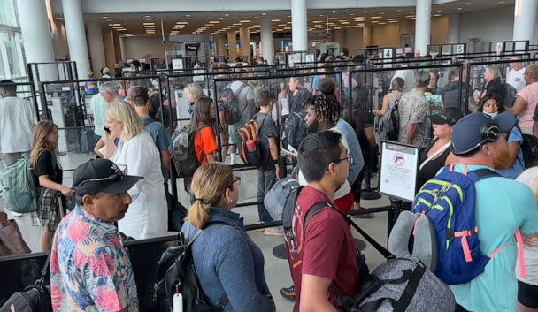 PHOTO: Passengers stand in line to go through security at Charlotte Douglas International Airport, July 2, 2022. (Daniel Slim/AFP via Getty Images)