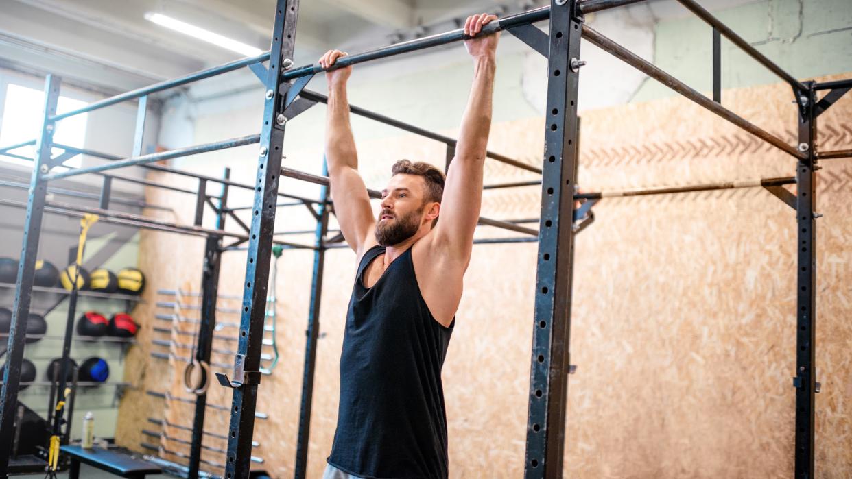  Man training on the horizontal bar at the gym 