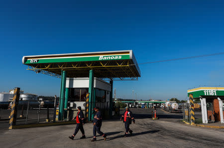 Workers walk in front of the entrance of the Petrobras Alberto Pasqualini Refinery in Canoas, Brazil May 2, 2019. Picture taken May 2, 2019. REUTERS/Diego Vara