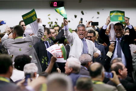 Members of the impeachment committee celebrate after voting on the impeachment of Brazilian President Dilma Rousseff at the National Congress in Brasilia, Brazil. REUTERS/Ueslei Marcelino