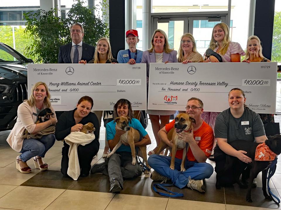 Lee Ann Furrow Tolsma (center top), CEO of Furrow Automotive Group, gathers with members of the Humane Society Tennessee Valley and Young-Williams Animal Center and several precious pups at the presentation of $10,000 to each organization at the Mercedes-Benz Knoxville dealership Thursday, July 21, 2022.