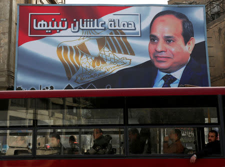 People look out of a bus window in front of a huge banner for Egypt's President Abdel Fattah al-Sisi from the campaign titled “Alashan Tabneeha” (So You Can Build It), for the upcoming presidential election in Cairo, Egypt, January 22, 2018. REUTERS/Amr Abdallah Dalsh