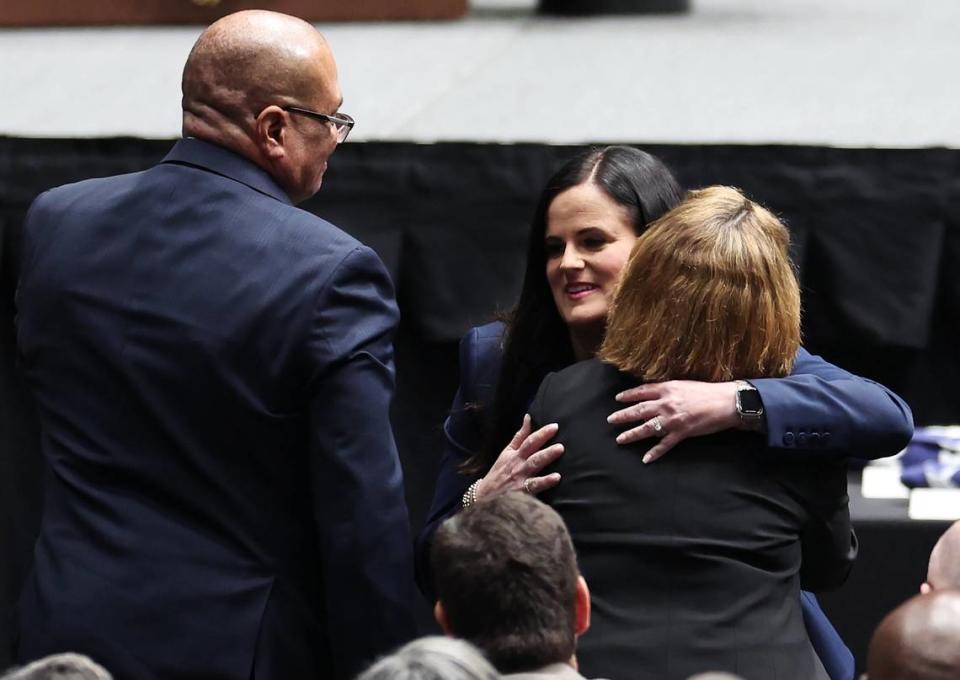 Kelly Weeks, center, the widow of slain Deputy U.S. Marshal Thomas Weeks Jr., hugs attendees at her husband’s memorial service as she went to the podium to speak at Bojangles Coliseum in Charlotte, NC on Monday, May 6, 2024. U.S. Marshal Weeks Jr., died during a standoff with a gunman on Monday, April 29th 2024.