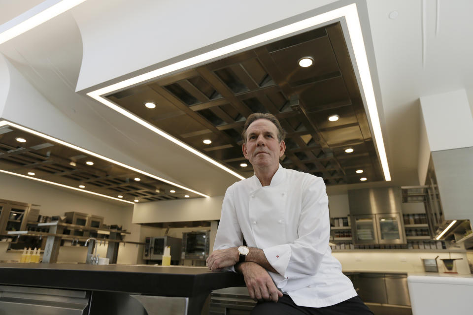 FILE - This March 9, 2017, file photo, shows celebrated chef Thomas Keller in the kitchen of his French Laundry restaurant in Yountville, Calif. A former employee of celebrated chef Thomas Keller is suing him and his three-star Michelin restaurants, Per Se in New York and the French Laundry in California, for discrimination, saying she was denied a job transfer and ultimately let go because she was pregnant. Vanessa Scott-Allen is seeking $5 million in damages for allegations that include sex discrimination and violation of pregnancy disability leave and says she hopes her trial, which starts Monday, June 3, 2019, will draw attention to a "culture of misogyny in fine dining," said her attorney, Carla Minnard. (AP Photo/Eric Risberg, File)