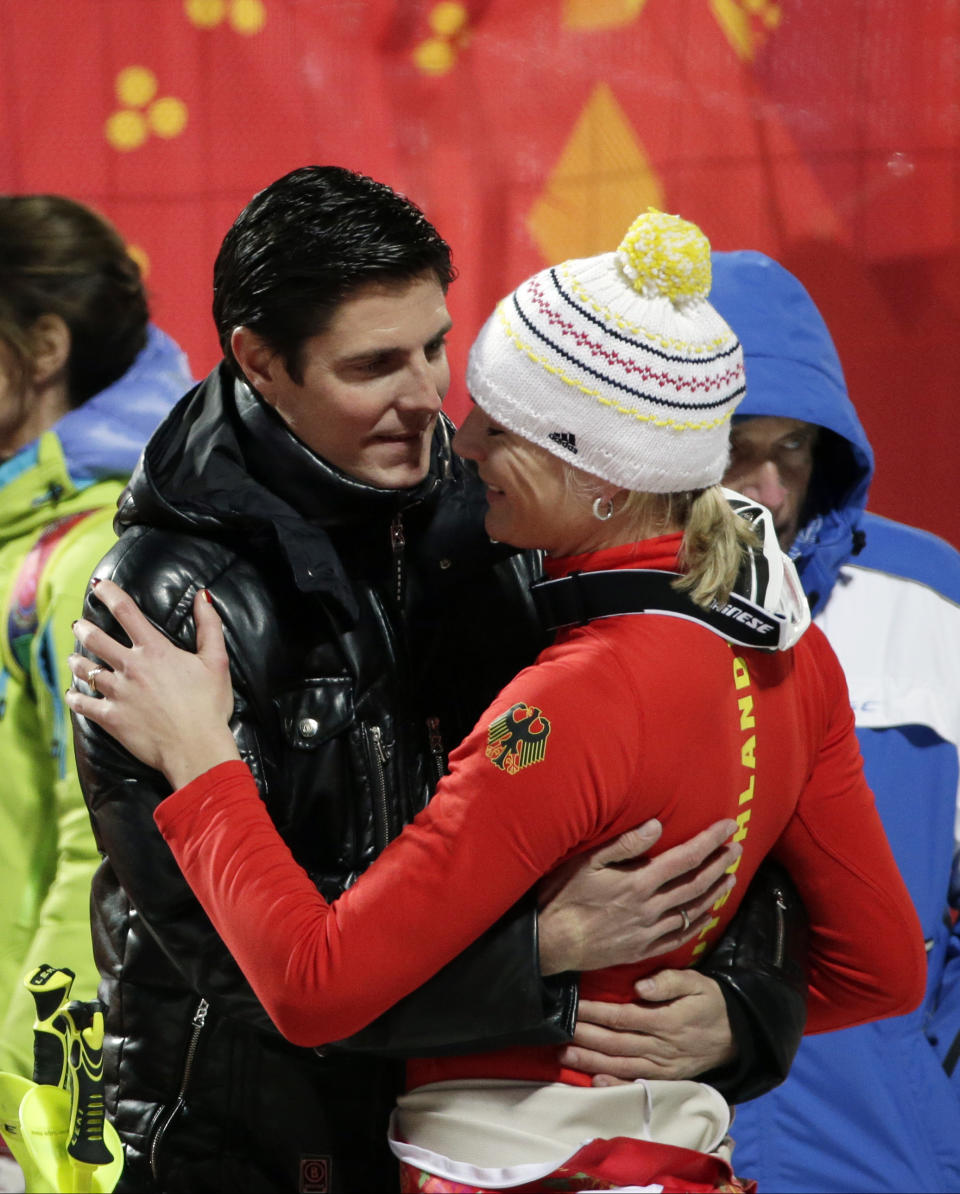 Germany's Maria Hoefl-Riesch is greeted by her husband, Marcus Hoefl after completing the second run of the women's slalom at the Sochi 2014 Winter Olympics, Friday, Feb. 21, 2014, in Krasnaya Polyana, Russia. (AP Photo/Gero Breloer)