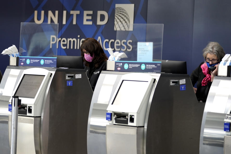 FILE - United Airlines employees work at ticket counters in Terminal 1 at O'Hare International Airport in Chicago, on Oct. 14, 2020. United Airlines said Wednesday, Sept. 8, 2021, that more than half its employees who weren't vaccinated last month have gotten their shots since the company announced that vaccines would be required. (AP Photo/Nam Y. Huh, File)