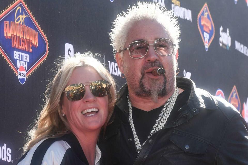 <p>Mindy Small/Getty</p> Guy Fieri and his wife Lori