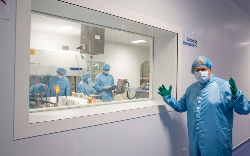 Boris Johnson stands by a viewing window at Oxford Biomedica, where technicians are manufacturing the AstroZeneca Covid vaccine - Heathcliff O'Malley 
