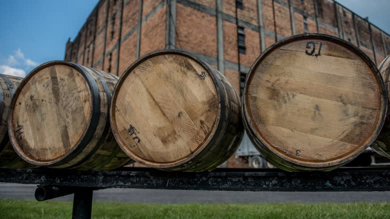 Whiskey barrels aging on a rack