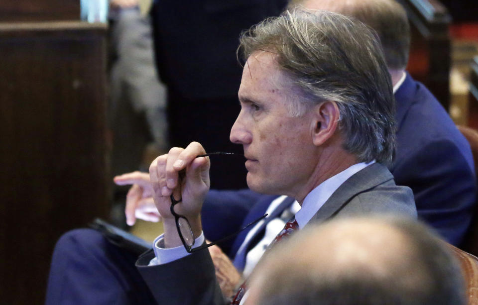 Mike Hunter, Oklahoma Attorney General, listens during the Opioid trial in Norman, Okla., Monday, June 24, 2019. Judge Thad Balkman announced Monday that he has signed off on the state's $85 million settlement with Israeli-owned Teva Pharmaceuticals following a squabble between the attorney general, Legislature and governor over how the deal was structured. (AP Photo/Sue Ogrocki)