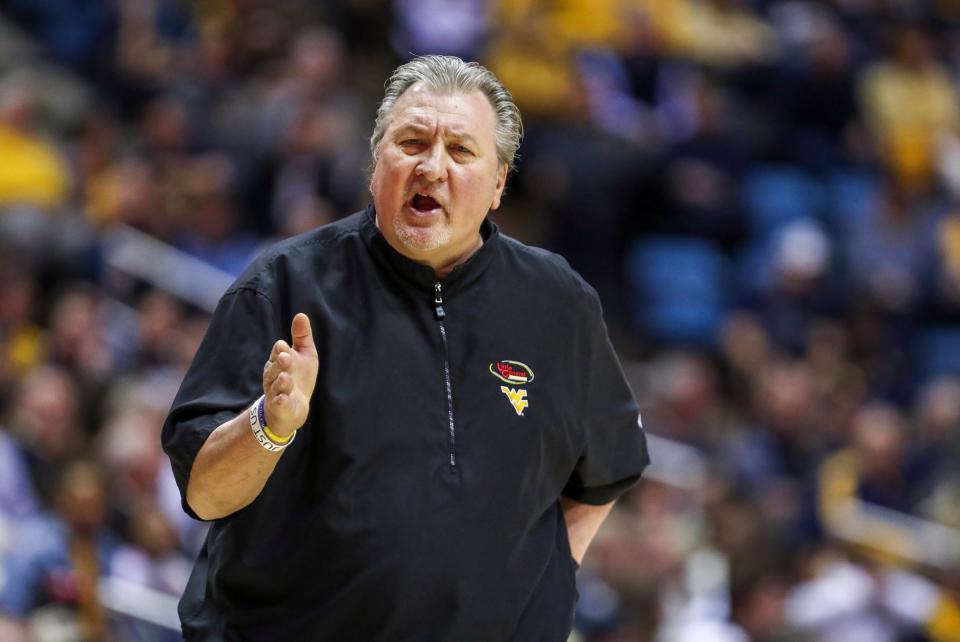 West Virginia basketball coach Bob Huggins used a homophobic slur multiple times when referring to Xavier University fans while on Monday's WLW-AM (700) talk show with host Bill Cunningham.