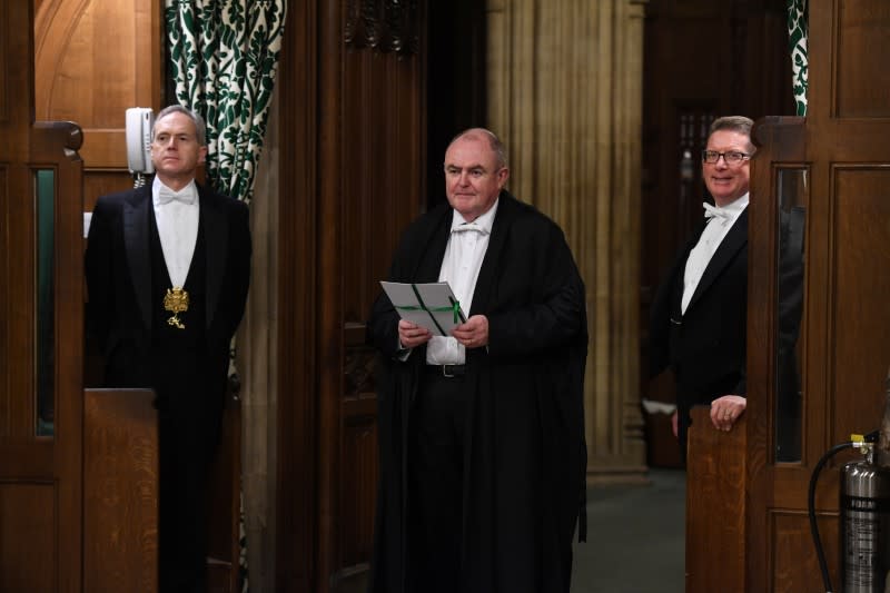 Clerk of Legislation Liam Laurence Smyth carries the European Union Withdrawal Agreement Bill between the two Houses of Parliament in London