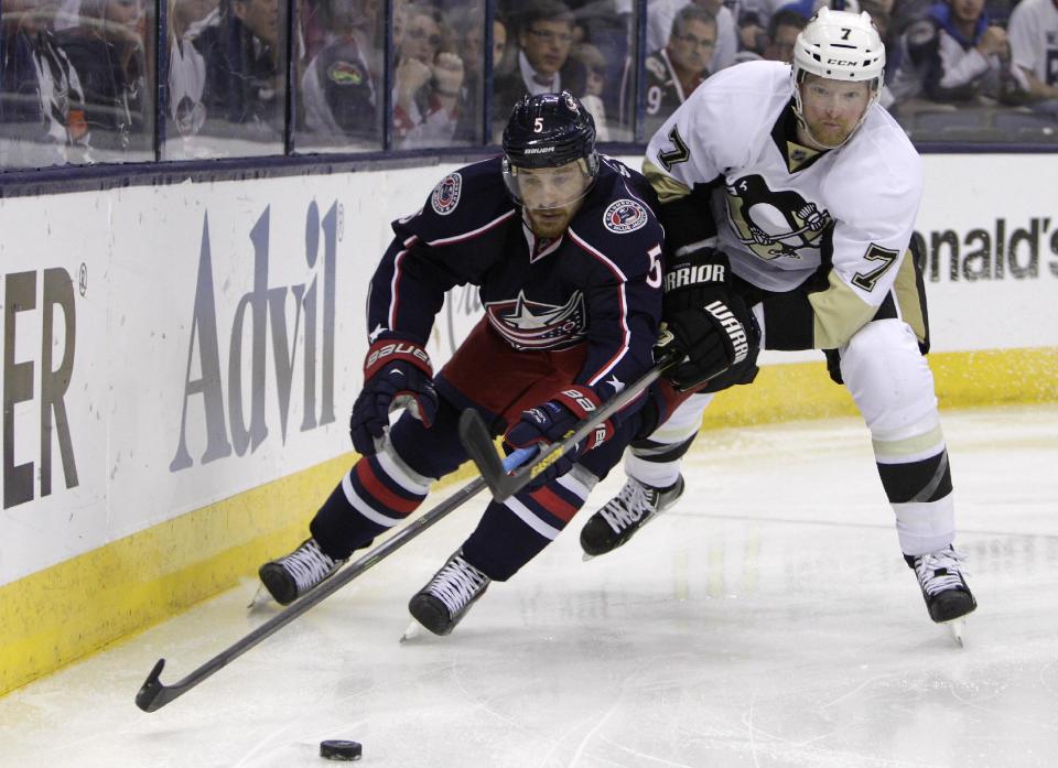 Columbus Blue Jackets' Jack Skille, left, tries to carry the puck past Pittsburgh Penguins' Paul Martin during the second period of Game 6 of a first-round NHL playoff hockey series Monday, April 28, 2014, in Columbus, Ohio. (AP Photo/Jay LaPrete)