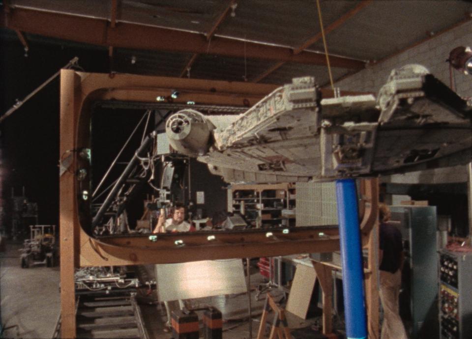 ILM artists work with a model of the Millennium Falcon in the Disney+ docuseries "Light & Magic."