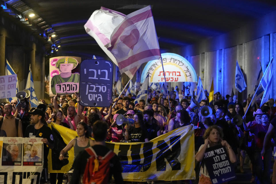 People take part in a protest against Israeli Prime Minister Benjamin Netanyahu's government, demanding new elections and the release of the hostages held in the Gaza Strip by the Hamas militant group, in Jerusalem, Monday, June 17, 2024. (AP Photo/Ohad Zwigenberg)