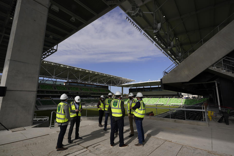 FILE - In this Jan. 25, 2021, file photo, dignitaries gather for a ribbon-cutting at Austin FC's new stadium under construction which has been named Q2 Stadium in Austin, Texas. Austin FC is MLS's newest expansion team and had to build the $260-million facility and a team roster amid the global pandemic. Austin FC opens the 2021 season Saturday, April 17, 2021, at Los Angeles FC. (AP Photo/Eric Gay, File)