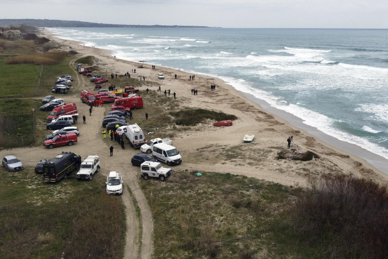 Firefighters search among debris washed ashore by sea at a beach near Cutro, southern Italy, Monday, Feb. 27, 2023. Nearly 70 people died in last week's shipwreck on Italy's Calabrian coast. The tragedy highlighted a lesser-known migration route from Turkey to Italy for which smugglers charge around 8,000 euros per person. (Giovanni Isolino/LaPresse via AP, File)