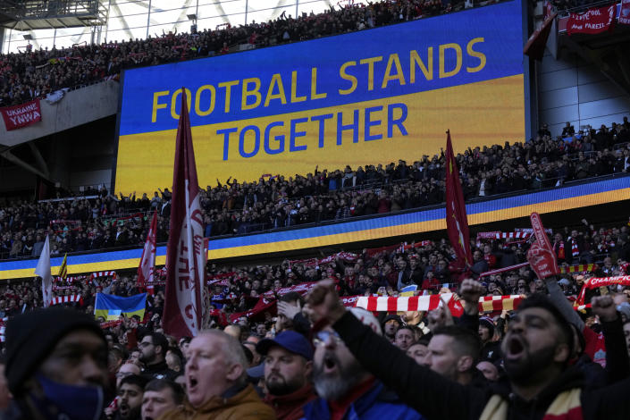 A video screen displays the Ukrainian flag, during the English League Cup final soccer match between Chelsea and Liverpool at Wembley stadium in London, Sunday, Feb. 27, 2022. (AP Photo/Alastair Grant)