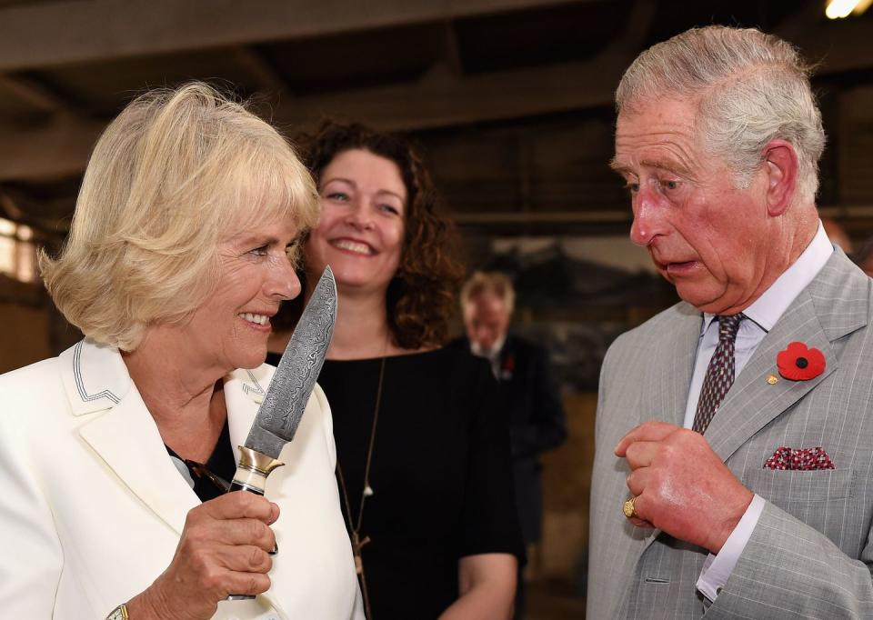 Camilla "scares" Charles with a knife.