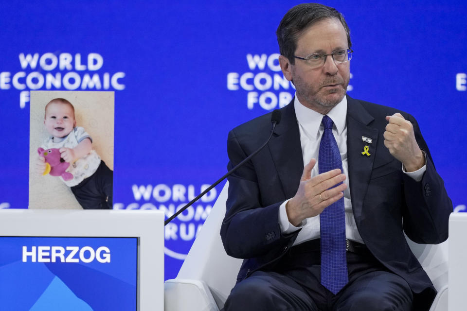 Israel's President Isaac Herzog during the Annual Meeting at the World Economic Forum in Davos, Switzerland, Thursday, Jan. 18, 2024. The picture next to President Isaac Herzog shows a baby taken hostage by Hamas during the Oct. 7 cross-border attack in Israel. The annual meeting of the World Economic Forum is taking place in Davos from Jan. 15 until Jan. 19, 2024. (AP Photo/Markus Schreiber)