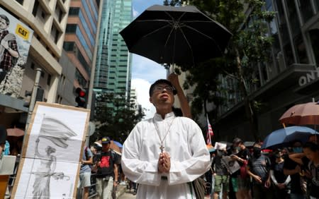 A priest prays as he attends a protest in Hong Kong