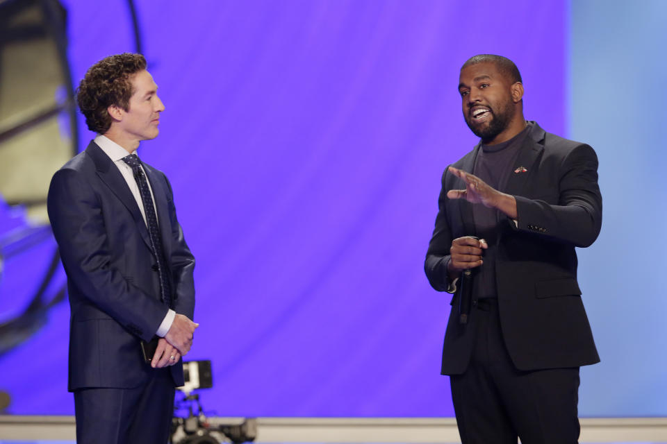 Rapper Kanye West, right, answers questions from Joel Osteen, left, during a service at Lakewood Church, Sunday, Nov. 17, 2019, in Houston.  (AP Photo/Michael Wyke)