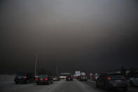 <p>Traffic makes their way south on I-15 as ash from the Holy Fire fills the air on Aug. 9, 2018 in Lake Elsinore, Calif. (Photo: Patrick Record/AP) </p>