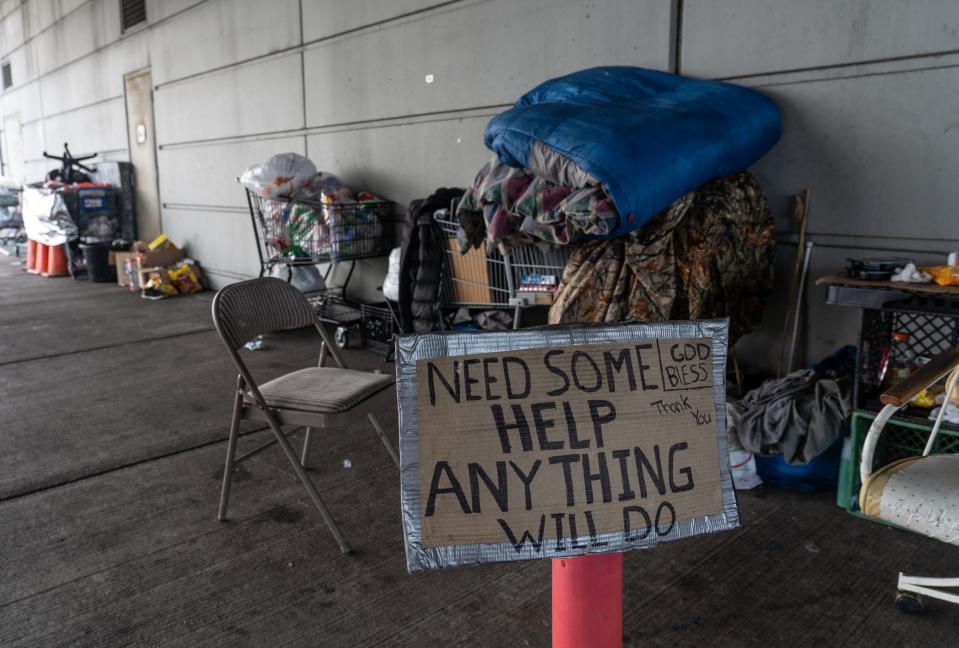 People's items sit in their sections at a homeless encampment at the intersection of 8 Mile Road and Woodward Avenue in Detroit on Tuesday, Aug. 11, 2020.