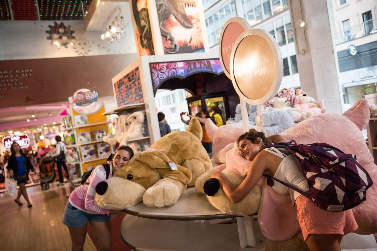 people play with giant stuffed animals at FAO Schwarz toy store on July 14, 2015 in New York City