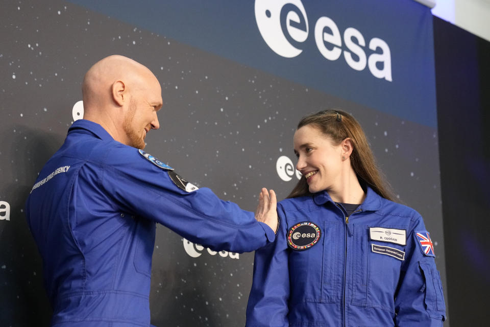 Astronauts crew leader Alexander Geerst, left, hands over the badge to Rosemary Coogan of Britain at the candidates of the Class of 2022 graduation ceremony at the European Astronaut Centre in Cologne, Germany, Monday, April 22, 2024. ESA astronaut candidates Sophie Adenot of France, Pablo Alvarez Fernandez of Spain, Rosemary Coogan of Britain, Raphael Liegeois of Belgium and Marco Sieber of Switzerland took up duty at the European Astronaut Centre one year ago to be trained to the highest level of standards as specified by the International Space Station partners. Also concluding a year of astronaut basic training is Australian astronaut candidate Katherine Bennell-Pegg, who has trained alongside ESA's candidates. (AP Photo/Martin Meissner)