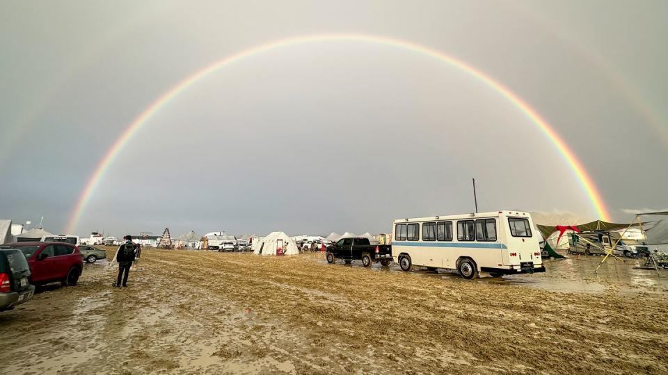 mandatory credit photo by diana jensenepa efeshutterstock 14080086a a person walks in the mud under a rainbow at the burning man festival in the black rock desert, nevada, usa, 02 september 2023 issued 03 september 2023 heavy rains in the normal dry location created deep, heavy mud conditions that made much of the area impassible and forced burning man organizers to close the entrance to the festival burning man festival 2023, black rock city, usa 02 sep 2023