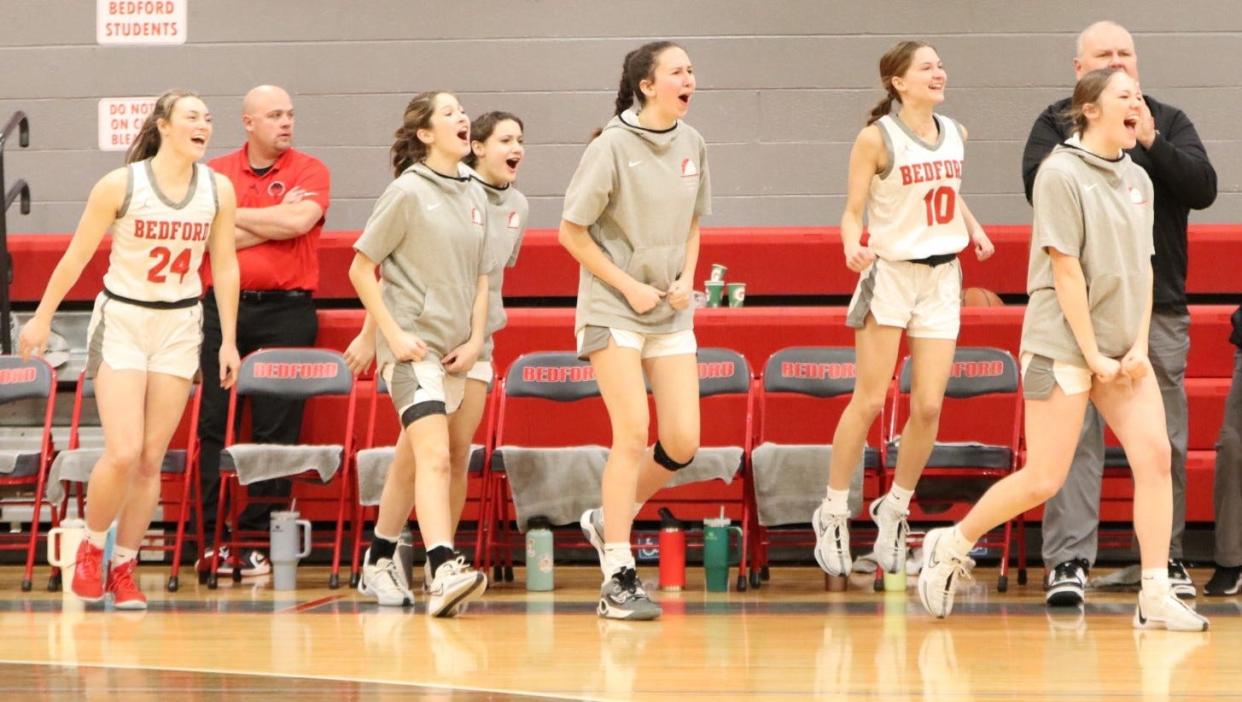 The Bedford bench jumps up for a time out after a scoring run that triggered a Dexter timeout Tuesday Bedford won 43-38 to clinch at least a share of the Southeastern Conference Red championship.