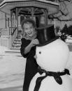 <p>While filming a Christmas episode of <em>Peyton Place, </em>Mia Farrow bundles up in aspirational winter wear while decorating a snowman.  </p>