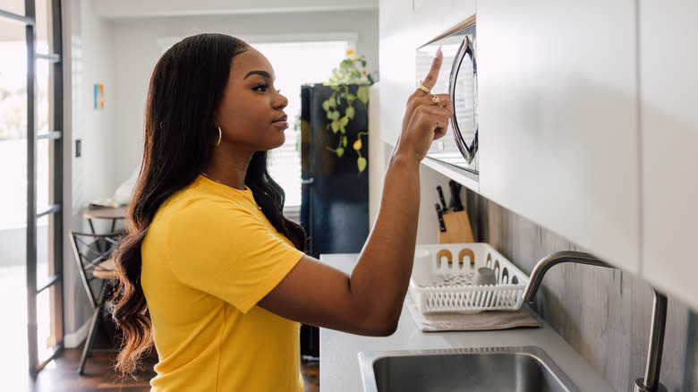 woman using microwave