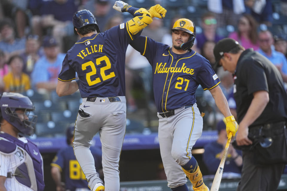 Milwaukee Brewers' Willy Adames, right, congratulates Christian Yelich after his solo home run off Colorado Rockies starting pitcher Dakota Hudson in the first inning of a baseball game, Wednesday, July 3, 2024, in Denver. (AP Photo/David Zalubowski)