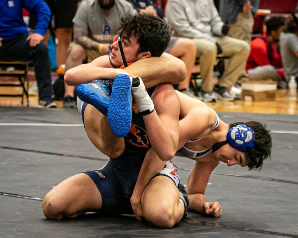 Blackman's James Revell works to break free from the leg grasp of Rockvale's Nathaniel Breeding in the 170-pound championship match at the Region 4-AA tournament Saturday at Riverdale. Revell captured the title with a 10-4 win.