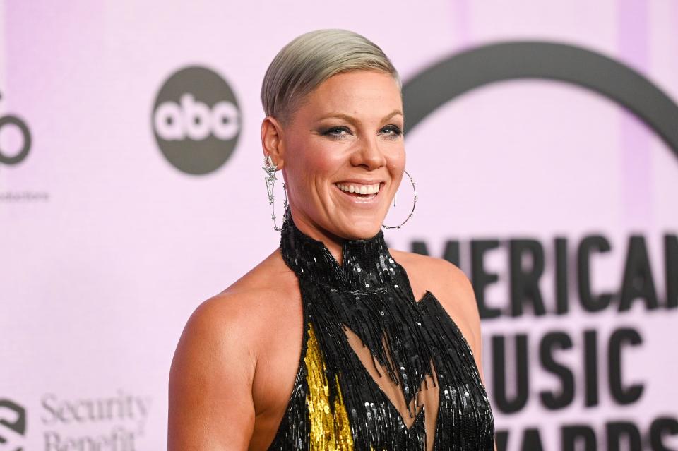 P!NK on the AMA red carpet in a black and yellow dress.