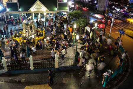 FILE PHOTO: Tourists pray at Erawan Shrine, a Hindu shrine popular among tourists in central Bangkok, Thailand, October 16, 2017. REUTERS/Athit Perawongmetha/File Photo