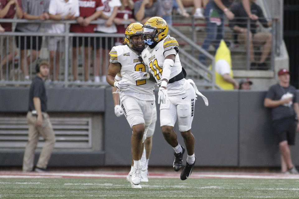 Idaho defensive back Marcus Harris, right, celebrates a Washington State fumble he returned for a touchdown, with Fa'Avae Fa'Avae during the first half of an NCAA college football game Saturday, Sept. 3, 2022, in Pullman, Wash. (AP Photo/Young Kwak)