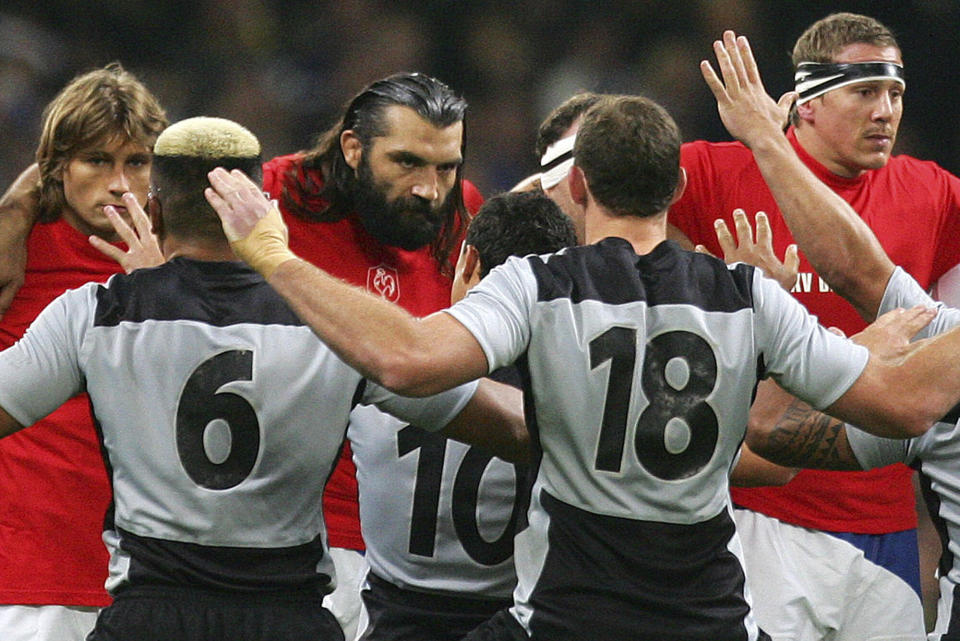 FILE - French players Dimitri Szarzewski, Sebastien Chabal and Imanol Harinordoquy, from left, face down their New Zealand counterparts who perform their pre-match Haka before the Rugby World Cup quarterfinal match between France and New Zealand at the Millennium Stadium in Cardiff, Wales, on Oct. 6, 2007. New Zealand rugby teams have been performing the haka before matches for 135 years. (AP Photo/Tom Hevezi, File)